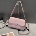 Pink crossbody square bag with woven texture and silver chain strap on marble surface - Pink