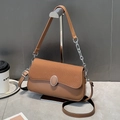 Detail of caramel crossbody bag featuring woven texture flap and round metal buckle - Khaki/Earth Yellow