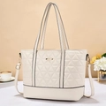 Chic off-white quilted tote bag with gold logo and dual straps in a lifestyle setting - Off-white