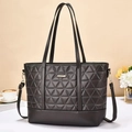 Detail of dark grey quilted tote bag with triangle stitching and adjustable strap - Gray