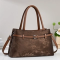 Brown vintage leather tote bag with top handles and adjustable strap on a minimalist desk - Coffee