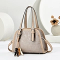 Detail of minimalist cream handbag with vertical texture and decorative wooden beaded tassel - Khaki