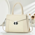 Detailed view of the mixed leather and woven texture handbag with metallic turn-lock - White