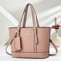 Detail of dusty rose tote bag featuring woven texture and gold hardware with shadows - Pink