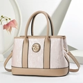 Detail of striped tote bag showing golden G metal logo and pink textured panel - Pink
