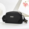 Minimalist black square crossbody bag with adjustable strap on decorative geometric props - Black