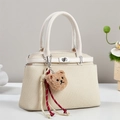 Minimalist beige woven crossbody bag with cute bear charm and silver metal hardware - Off-white