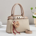 Chic woven trapezoid handbag with beige leather handles and cute bear charm accent - Khaki