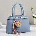 Light blue woven texture crossbody bag with silver twist lock and cute bear charm - Blue