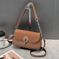 Detail of a brown crossbody bag with woven texture lid and silver round buckle closure - Brown
