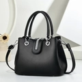 Macro shot of black PU leather bag with sparkling rhinestone strip and silver hardware - Black
