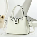 Detail of minimalist cream leather handbag with sparkling rhinestone flap and silver ring hardware - Off White