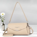 Elegant beige leather crossbody bag with metal trim shown in a minimalist studio setting - Light Khaki