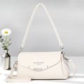 Detail of lychee pattern leather handbag with silver metallic trim and adjustable strap - Off-white