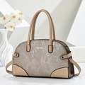Beige textured stitching handbag with silver metallic finish and top handles on clean background - Khaki