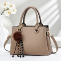 Detail of khaki textured PU leather tote bag with braided charms and furry ball pendant - Khaki