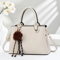 Detail of cream herringbone faux leather bag with gold rings and brown pompom charm - Off-white