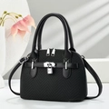 Detail of black crossbody bag with silver hardware lock and dual zipper design - Black