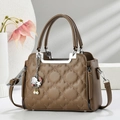 Detailed texture of brown quilted leather bag with starfish and pearl charm accessory - Khaki