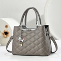 Dark grey quilted handbag with lychee pattern and starfish charm in a modern setting - Gray