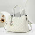Detail of white quilted handbag with silver U-shaped metal handle and pearl charm - White