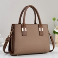 Brown woven texture handbag with golden buckle and adjustable strap in a 45-degree view - Brown