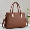 Dark brown lychee grain leather handbag with gold wheat hardware from a 45-degree angle - Brown