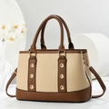 Detail of beige and brown lychee grain faux leather handbag with gold metal rings - Apricot