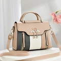 Vintage color block crossbody bag with elegant golden swan clasp on a white pedestal - Khaki