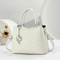Elegant off-white quilted leather handbag with shell pendant and silver handle - White