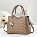 Detail of brown quilted leather handbag with pearl starfish charm and silver metal accents - Khaki