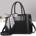 Detail of black tote bag featuring matte leather stitching and decorative floral silk scarf - Black