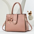 Elegant rose pink lychee leather tote bag with pearl bow charm and metal clasp detail - Pink