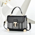 Chic black leather and tweed crossbody bag for women with gold hardware on white pedestal - Black