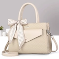 Detail of beige woven texture bag featuring printed silk scarf bow and silver hardware - Apricot