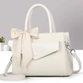 Detail of cream leather handbag with silk scarf bow and elegant textured finish - Off White