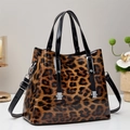 Leopard print crossbody handbag in glossy finish with silver metal hardware on a white table - Khaki/Earth Yellow