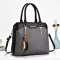 Chic patchwork handbag with textured weaving, gold logo detail and a star charm - Black