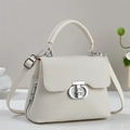 Detailed view of cream textured handbag featuring a silver CD buckle and zip side details - Off-white