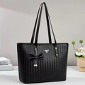 Elegant black woven tote bag with triangular metal logo and pearl bow charm accessory - Black