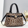 Chic leopard print handbag in glossy patent leather with gold hardware and top handle - Khaki