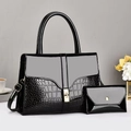 Detail der glänzenden schwarzen Krokodil-Handtasche und Tasche mit goldenem Schloss - Schwarz