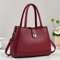 Elegant burgundy leather bucket bag with litchi texture and silver twist lock closure - Red