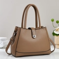 Classic brown pebble leather bucket bag with top handle and silver buckle detail - Khaki