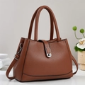 Elegant brown pebbled leather bucket bag with dual handles and silver turn-lock closure - Khaki/Earth Yellow