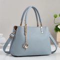 Litchi pattern leather shoulder bag in fog blue with golden floral pendant and strap - Blue