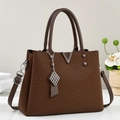 Brown woven texture tote bag with metallic V-shaped charm and adjustable shoulder strap - Coffee