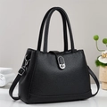 Detail of black lychee grain leather bucket bag with silver metal twist lock and strap - Black
