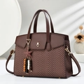 Retro brown herringbone crossbody bag with heart buckle and star pendant in sunlight - Coffee