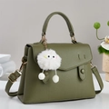 Olive green pebbled leather handbag with cute white plush monster charm for women - Green